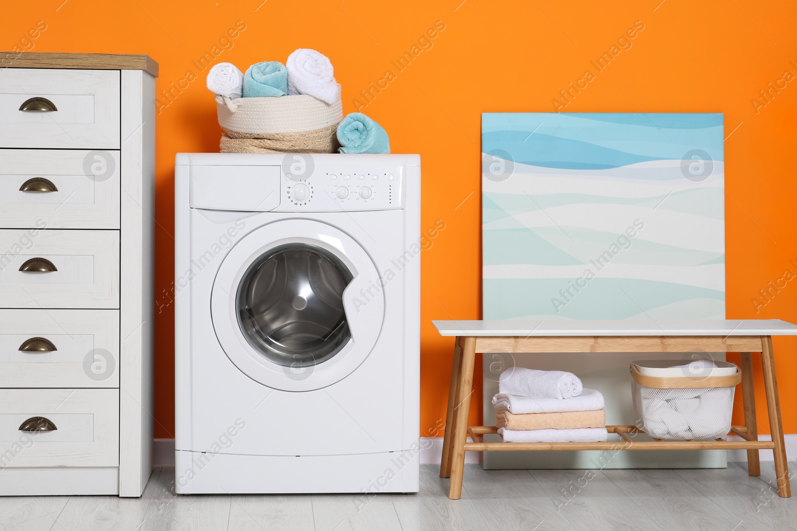 Photo of Stylish laundry room with washing machine. Interior design