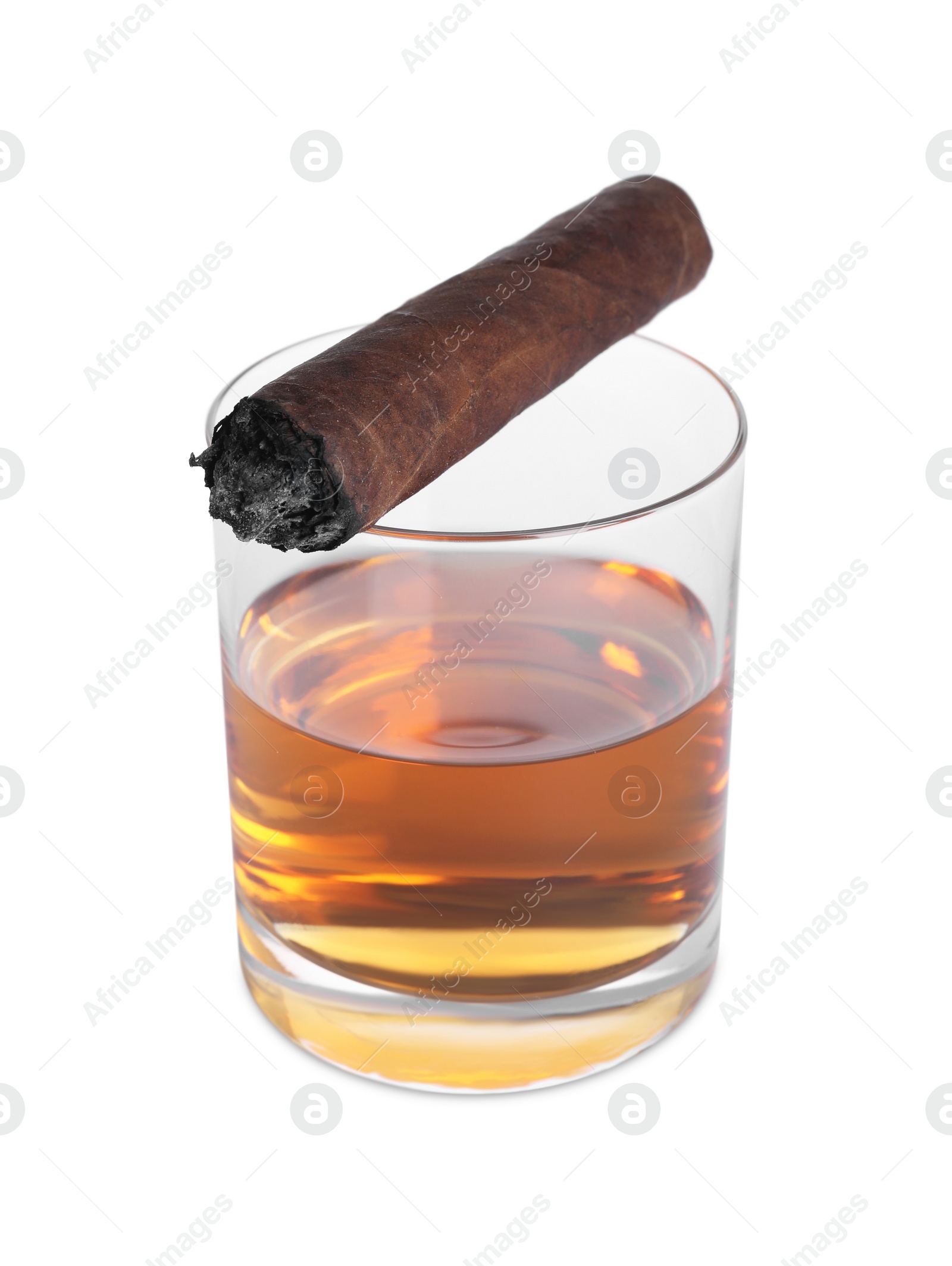 Photo of Glass of whiskey and burnt cigar isolated on white