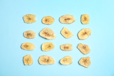 Flat lay composition with banana slices on color background. Dried fruit as healthy snack