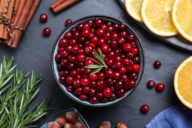 Photo of Flat lay composition with fresh ripe cranberries on dark grey table