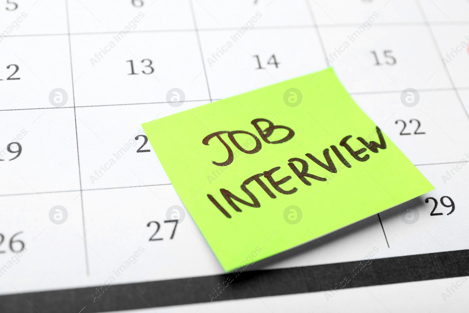 Photo of Reminder note about job interview on calendar, closeup