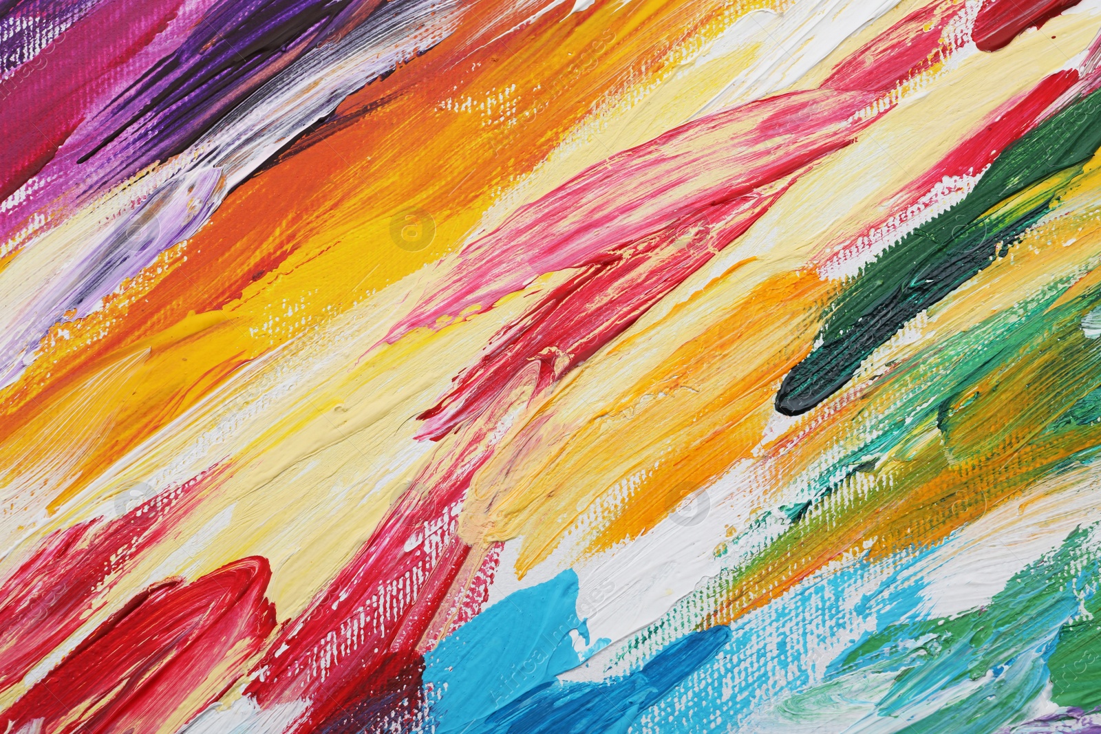 Photo of Beautiful strokes of colorful oil paints on white canvas as background, closeup