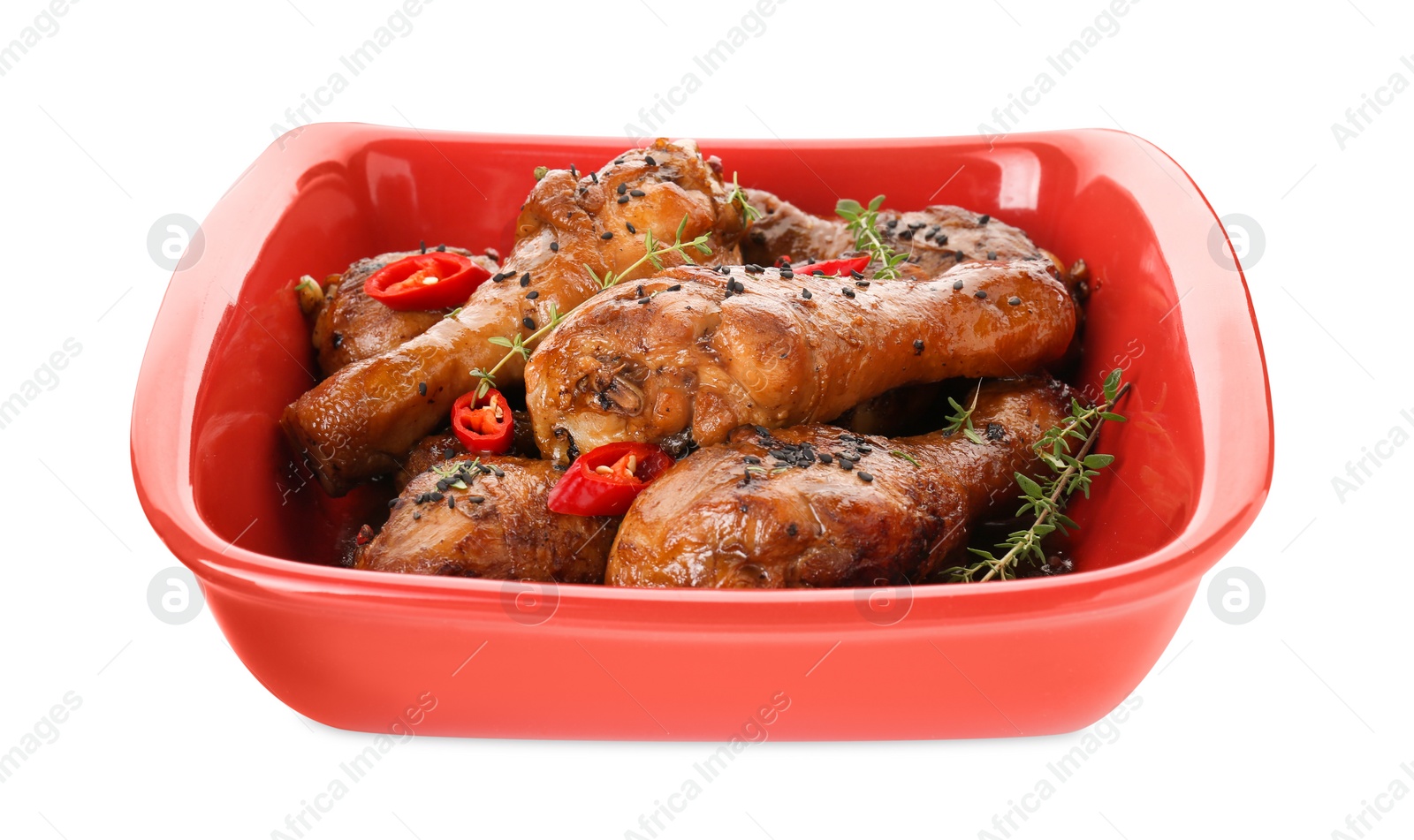 Photo of Chicken legs glazed with soy sauce, black sesame, chili and thyme isolated on white