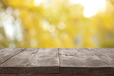 Image of Empty wooden surface against blurred background. Bokeh effect