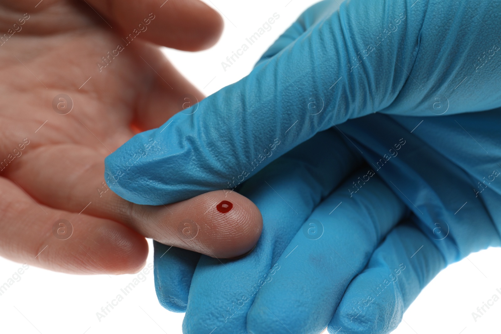 Photo of Doctor taking blood sample from patient's finger on white background, closeup