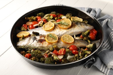 Photo of Baked fish with vegetables, rosemary and lemon on white wooden table, closeup