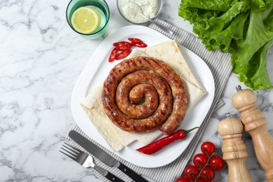 Photo of Tasty homemade sausage with chili pepper and lavash served on white marble table, flat lay