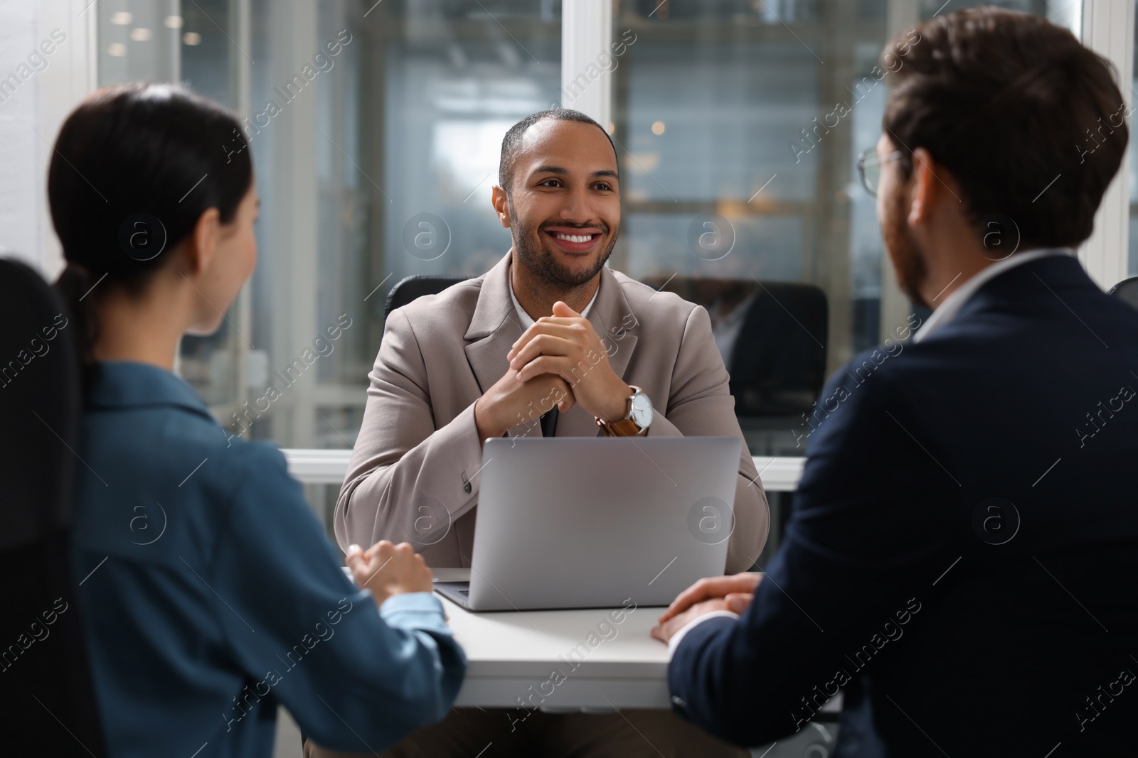 Photo of Lawyer working with clients at table in office