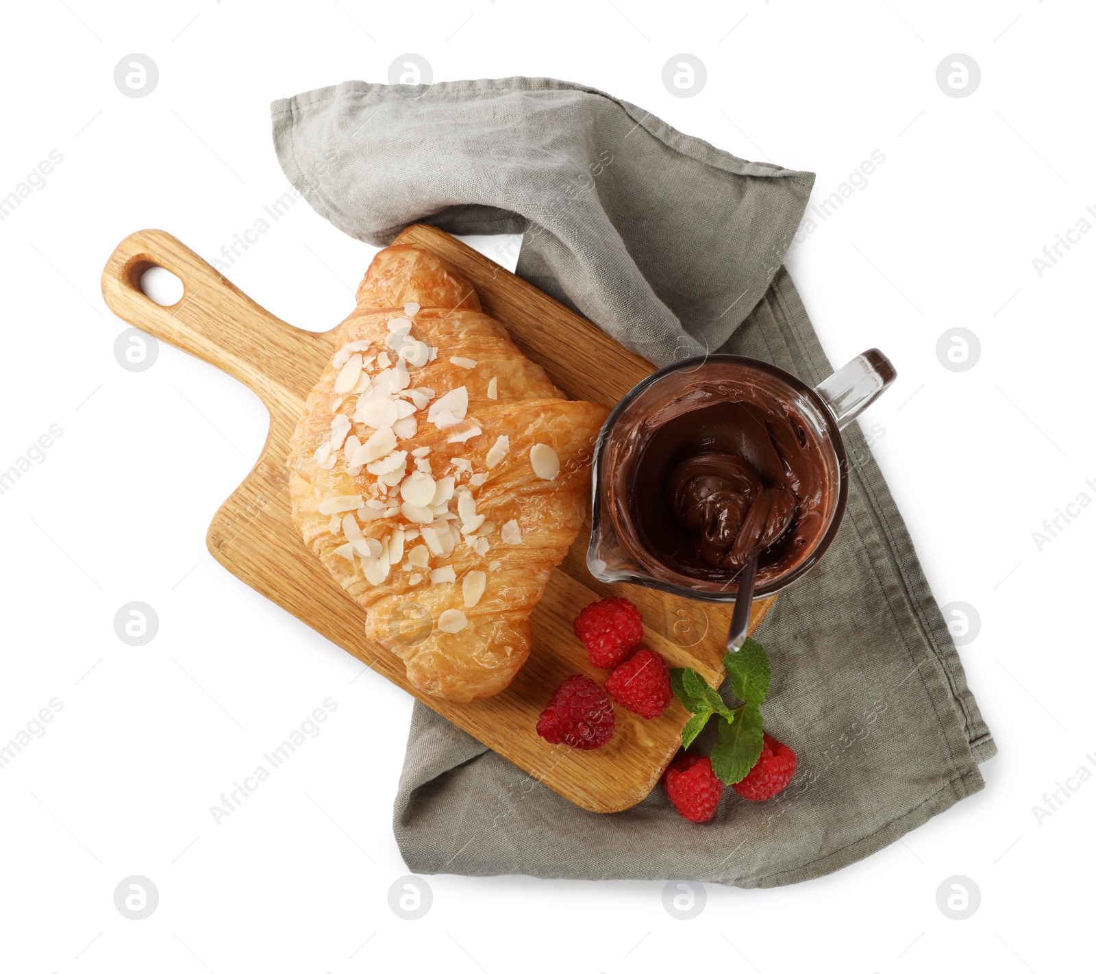 Photo of Delicious croissant with almond flakes, chocolate and raspberries isolated on white, top view