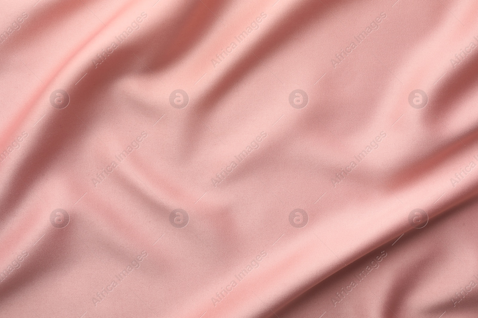 Photo of Crumpled pink silk fabric as background, top view