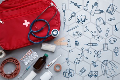 Image of First aid kit and different images on grey table, flat lay