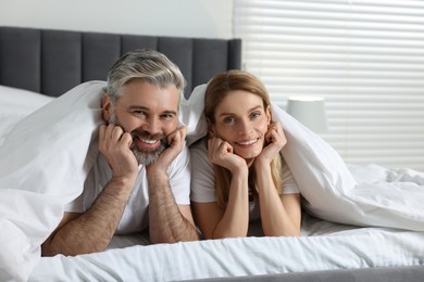 Photo of Lovely mature couple in bed at home