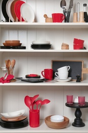 White shelving unit with set of dishware