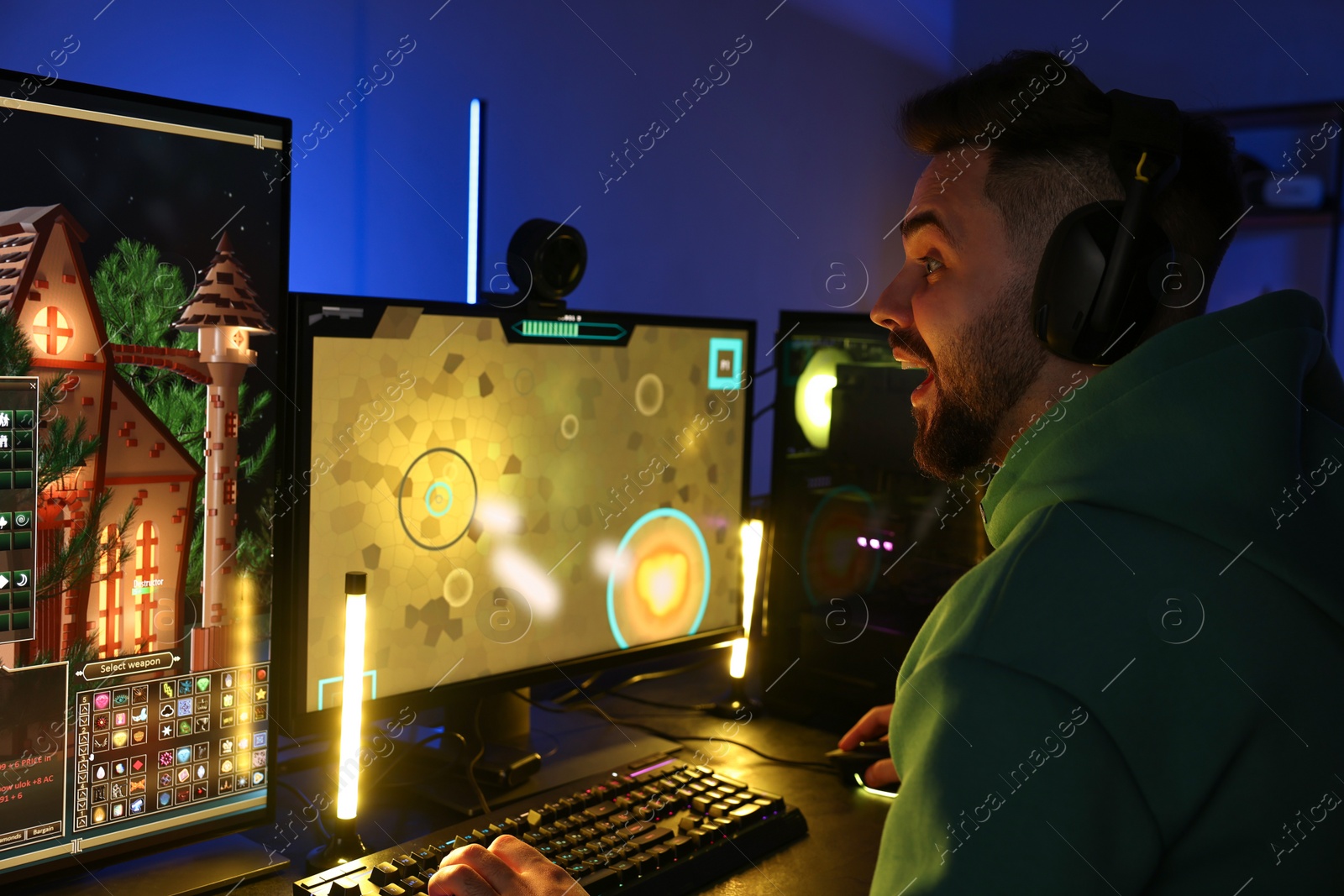 Photo of Man playing video games on computer at table indoors