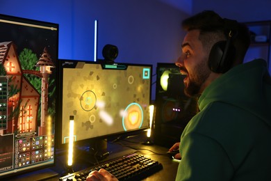 Photo of Man playing video games on computer at table indoors