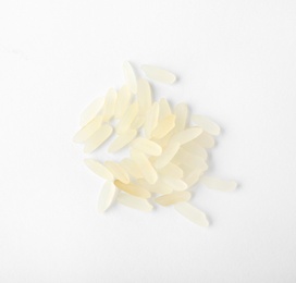 Uncooked parboiled rice on white background, top view