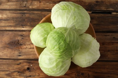 Ripe white cabbage on wooden table, top view