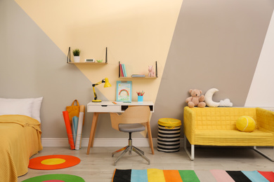 Stylish child room interior with comfortable bed and desk