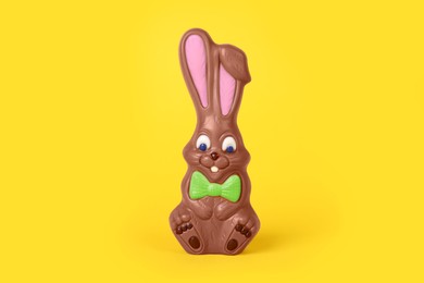 Chocolate bunny on yellow background. Easter celebration