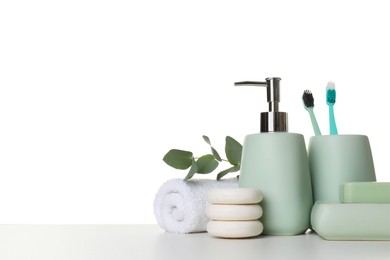 Bath accessories. Different personal care products and eucalyptus branch on table against white background. Space for text