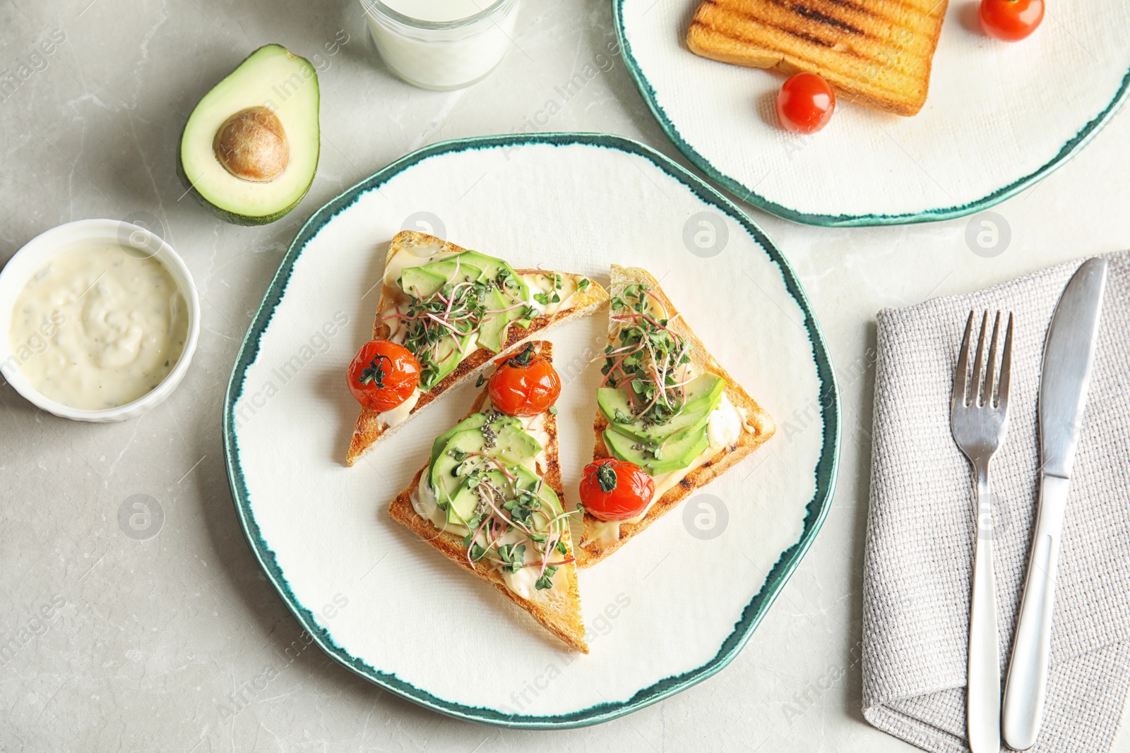 Photo of Tasty toasts with avocado, sprouts and chia seeds served on table, top view