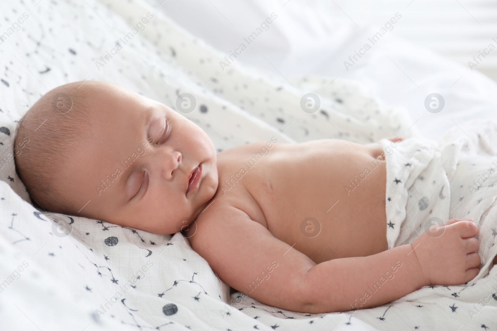 Photo of Cute little baby sleeping in bed, closeup view