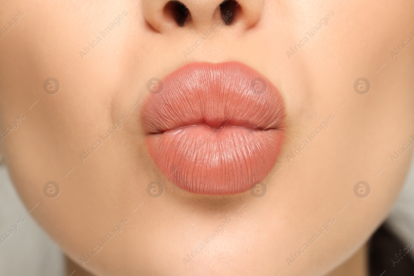 Photo of Closeup view of woman with nude lipstick