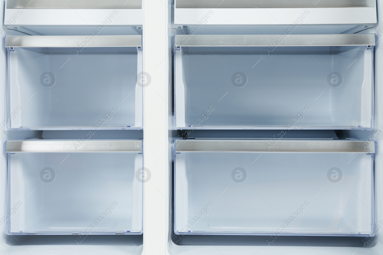 Photo of Shelves of empty modern refrigerator, closeup view