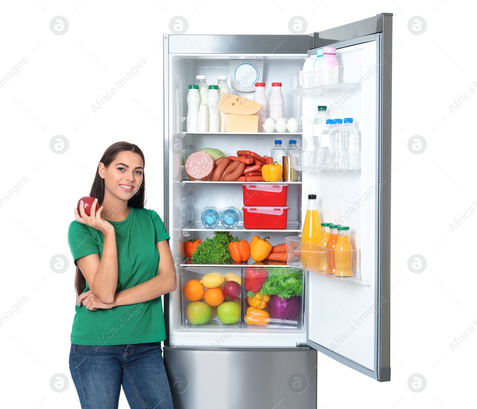 Photo of Young woman with apple near open refrigerator on white background