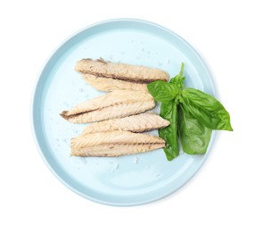 Photo of Plate with canned mackerel fillets and basil isolated on white, top view