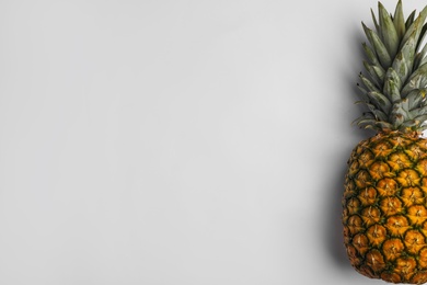 Tasty whole pineapple with leaves on white background, top view