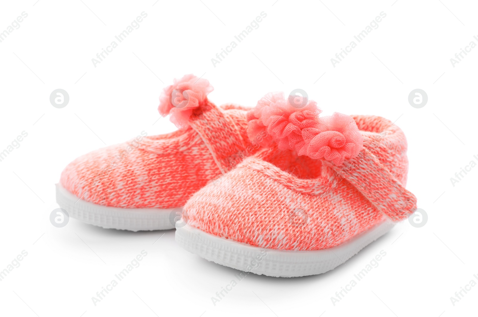 Photo of Pair of pink baby shoes on white background