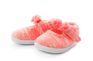 Pair of pink baby shoes on white background