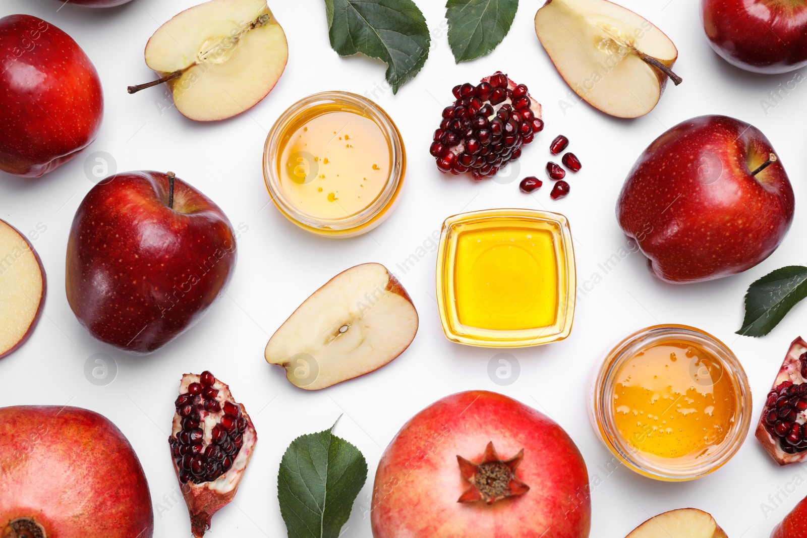 Photo of Honey, apples and pomegranates on white background, flat lay. Rosh Hashanah holiday