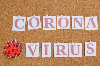 Photo of Words CORONA VIRUS pinned to corkboard, top view