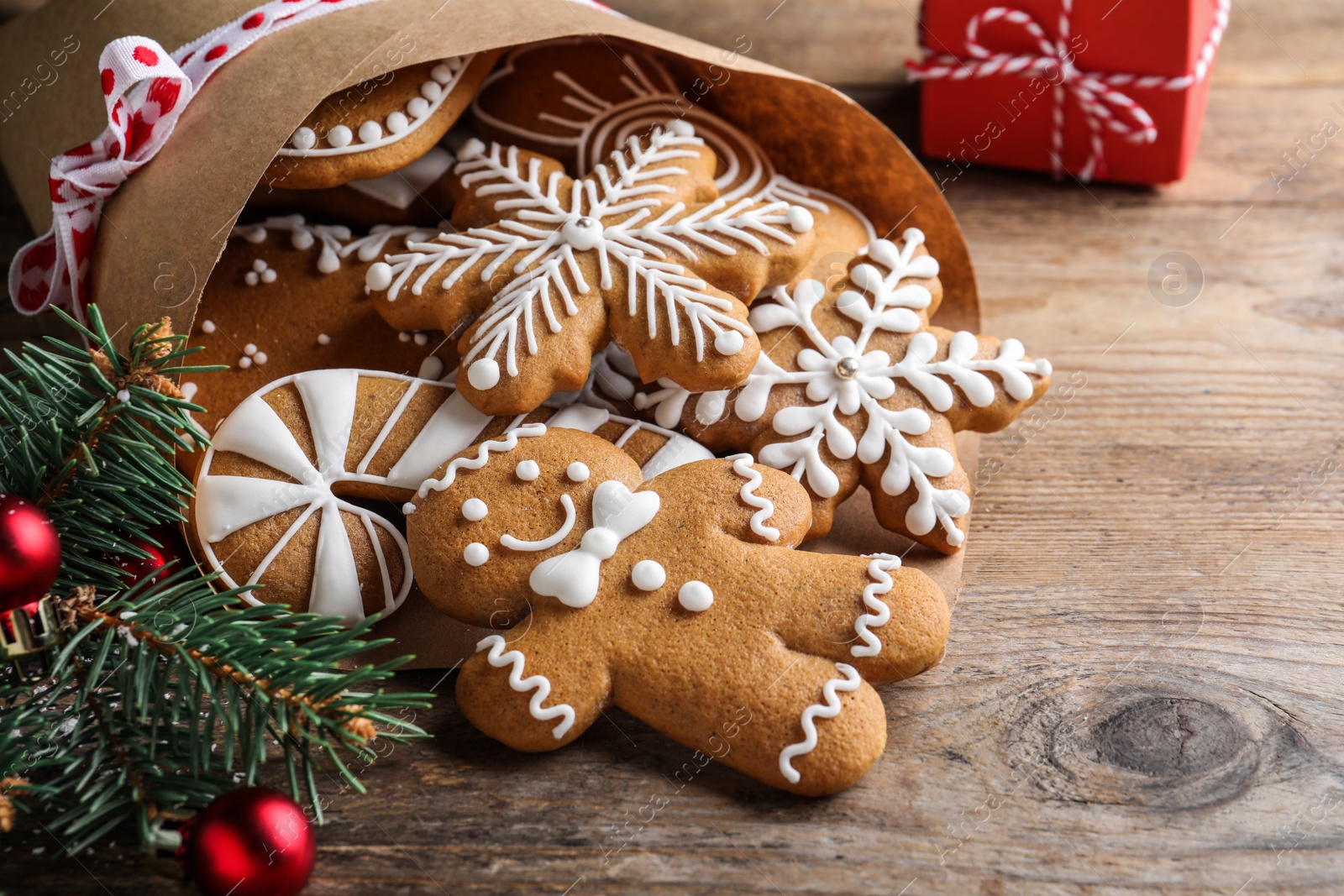 Photo of Tasty Christmas cookies on wooden table, closeup