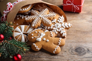 Photo of Tasty Christmas cookies on wooden table, closeup