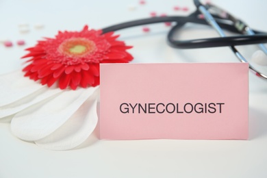 Composition with menstrual pads and flower on color background. Gynecological checkup