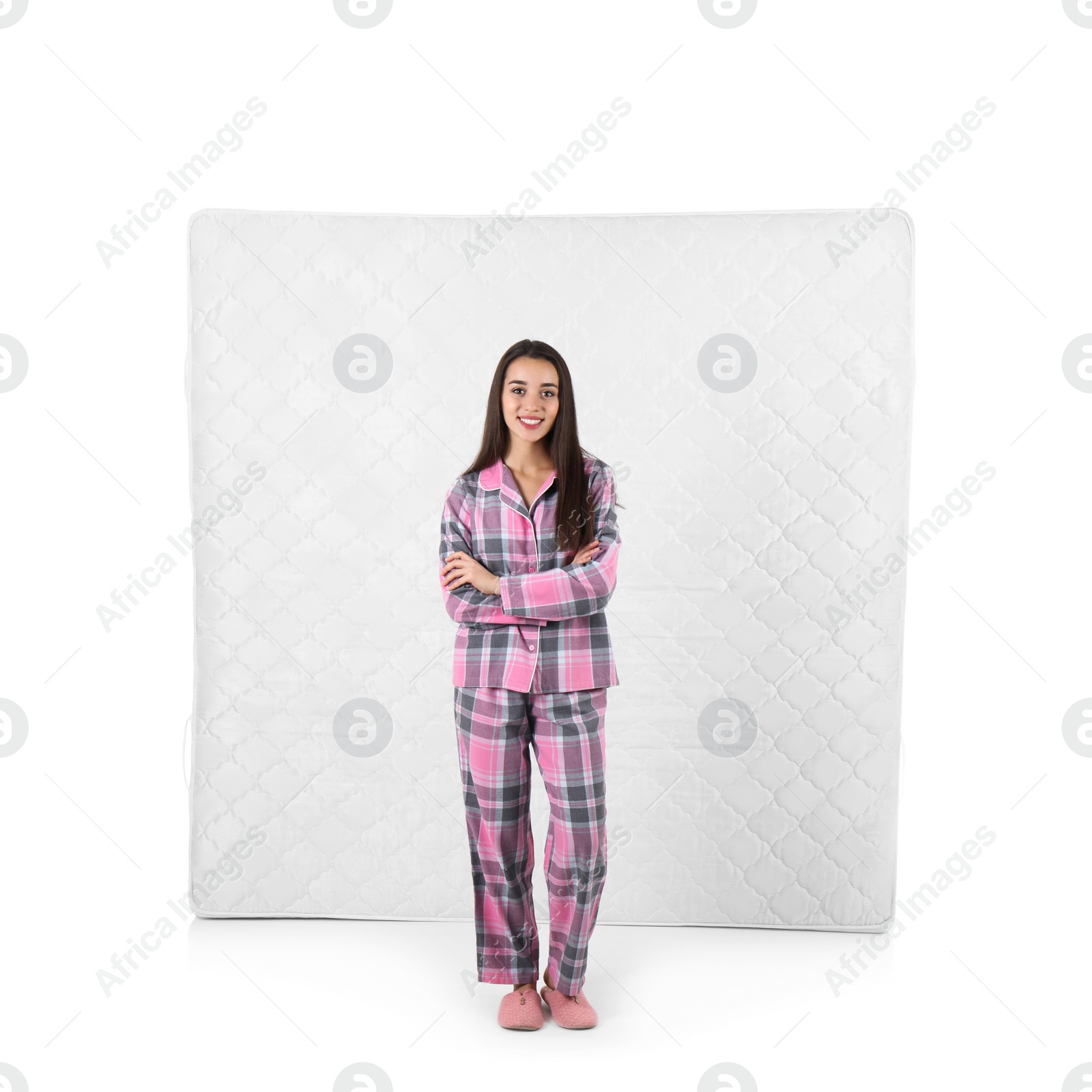 Photo of Young woman with comfortable mattress isolated on white