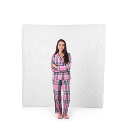 Young woman with comfortable mattress isolated on white