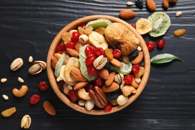 Photo of Flat lay composition of different dried fruits and nuts on color wooden background