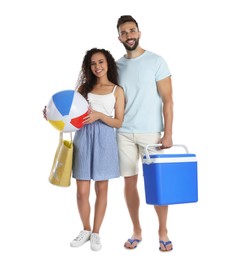 Photo of Happy couple with cool box and beach ball on white background