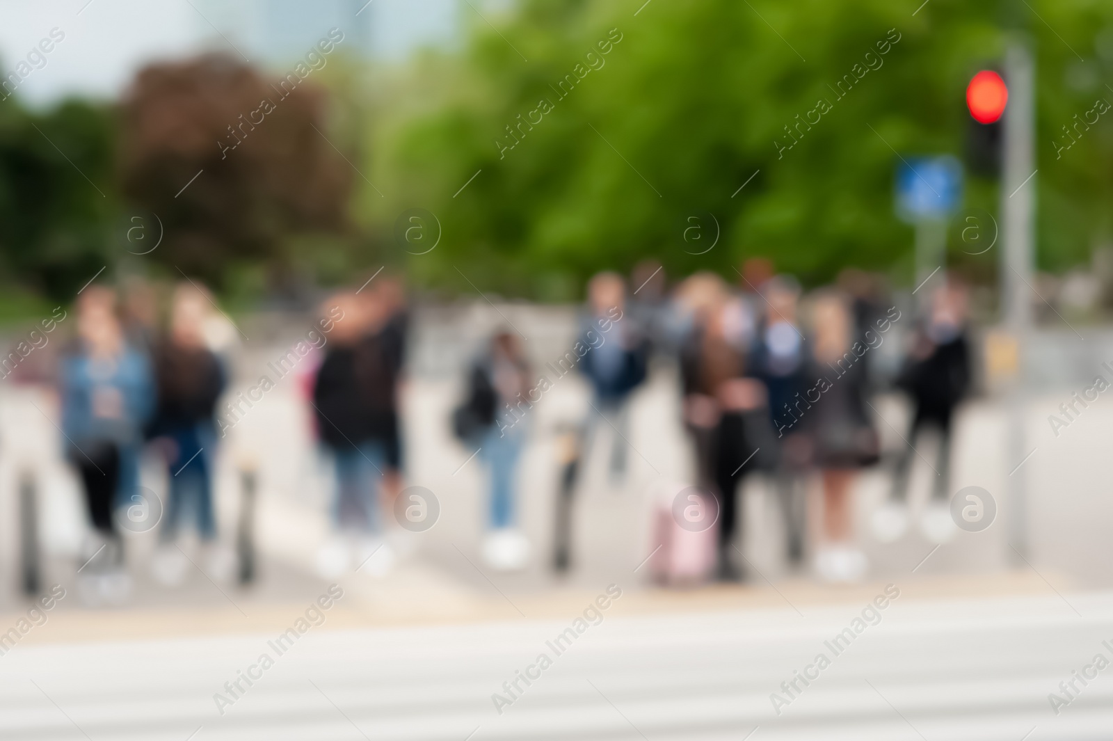 Photo of People waiting to cross street in city, blurred view