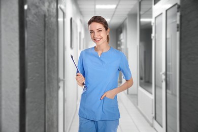 Nurse with clipboard in uniform at hospital