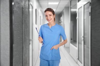 Image of Nurse with clipboard in uniform at hospital