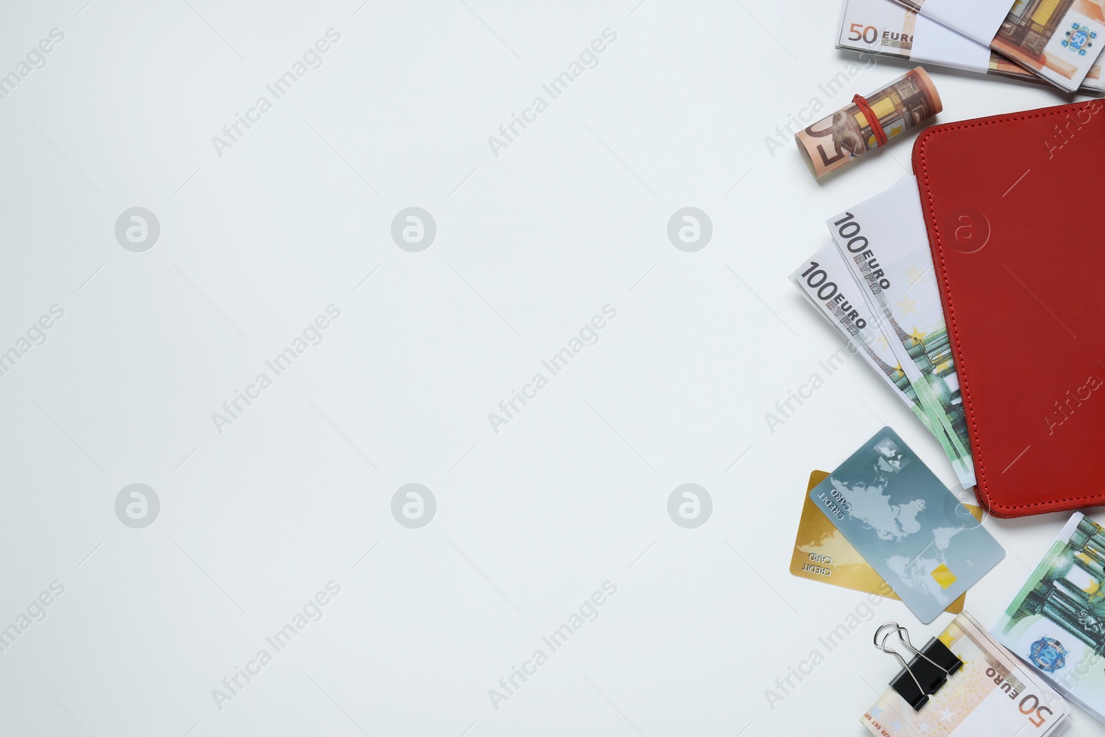 Photo of Wallet, different Euro banknotes and credit cards on white table, flat lay with space for text. Money exchange