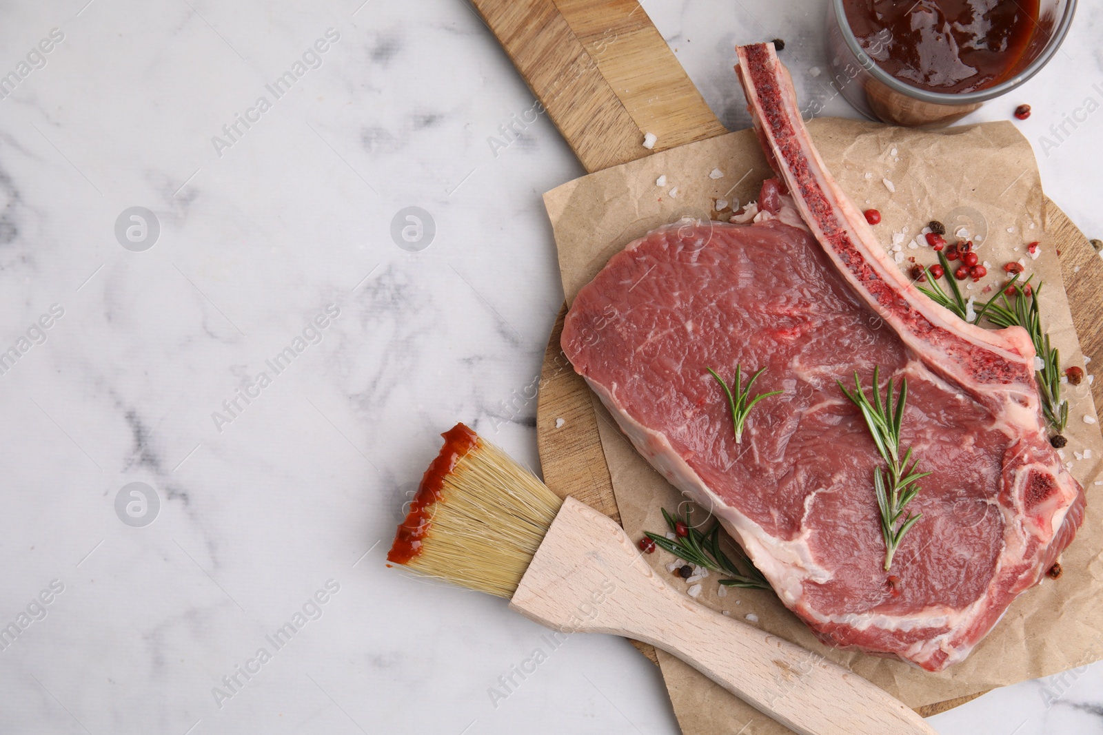 Photo of Raw meat, rosemary, marinade and spices on white marble table, top view. Space for text