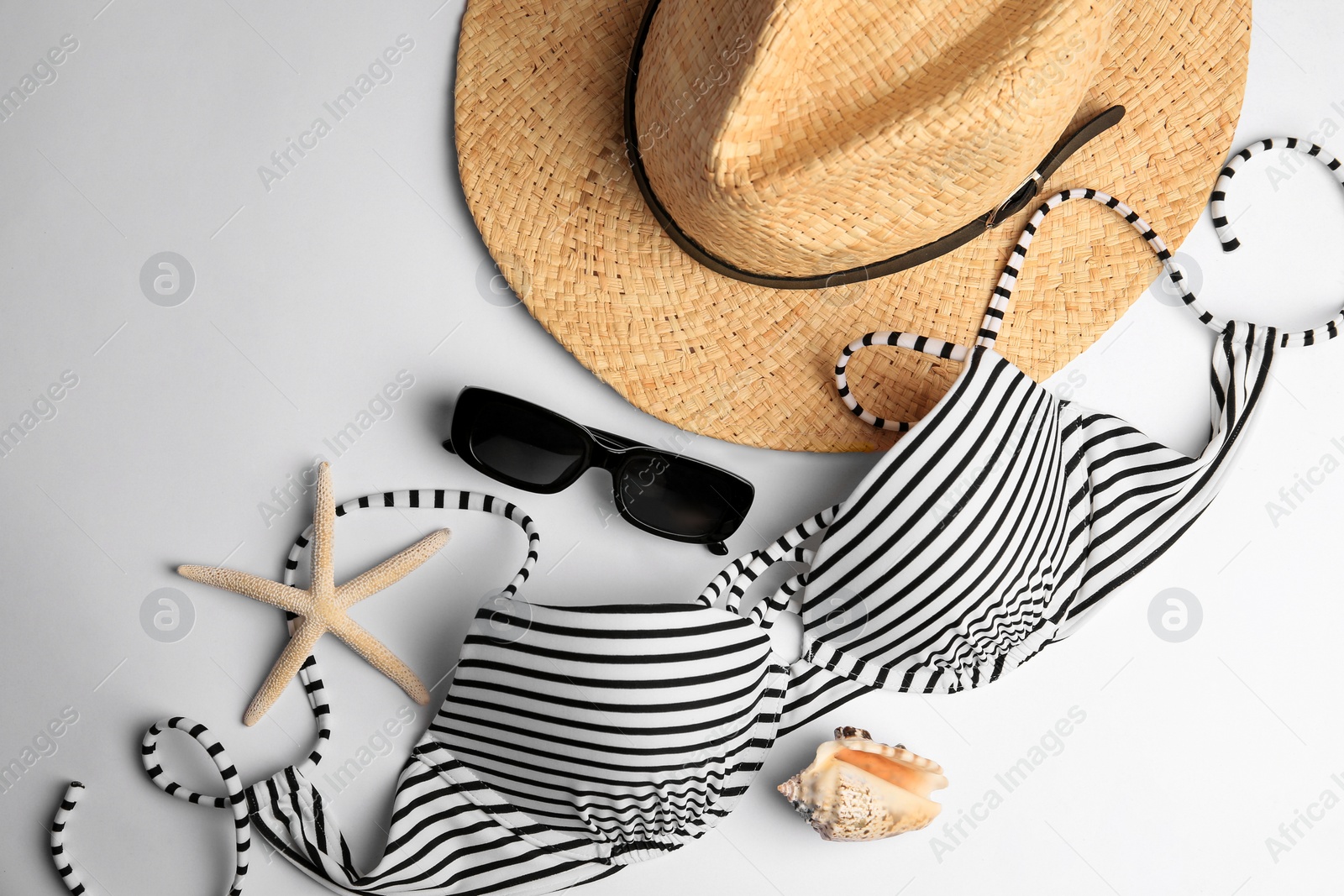 Photo of Flat lay composition with beach accessories on white background