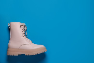 Photo of Stylish leather shoe on light blue background, top view. Space for text