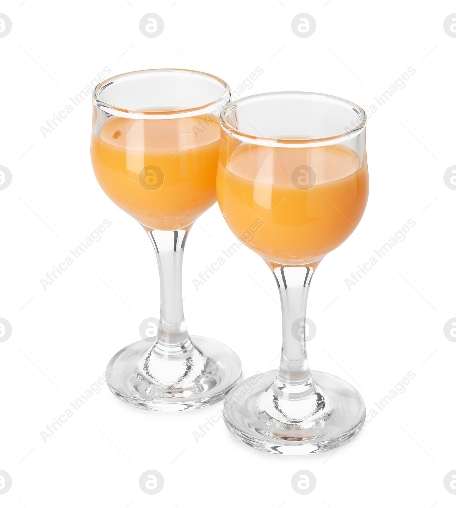 Photo of Tasty tangerine liqueur in glasses isolated on white